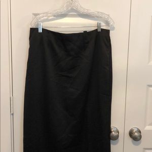 Long black satin skirt.  Tulip kick in back.
